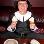 (Courtesy Photo) J.P. Licks owner Vince Petryk poses as a Pilgrim last month at the 659 Centre St. shop while showing off Thanksgiving-themed ice cream flavors. The store is offering more special flavors for December, including candy cane, egg nog and red velvet.