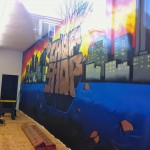 (Gazette Photo by Rebeca Oliveira) B’s Chop Shop’s new mural depicts the Boston skyline.