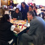 (Courtesy Photo) U.S. Secretary of Education Arne Duncan (right) visits with parents at the Kennedy School on Feb. 6 while Boston Public Schools Superintendent Carol Johnson (rear center) looks on.