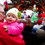 Baby Camila enjoys the crowd and lights in Hyde Square. (Photo by Daniella Rascón)