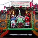 Raggedy Ann, a living Christmas tree and a toy soldier wave to children from the holiday trolley in Monument Square. (Photo by Daniella Rascón)