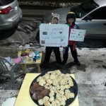(Courtesy Photo) Adam Crellin-Sazama (left) and friend Franz Criscione hawk their goods on a snowy day last month.