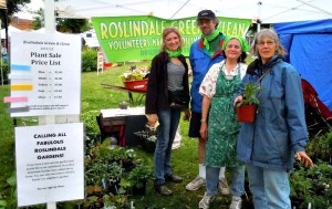 (Courtesy Photo) Roslindale Green & Clean staffers Brooke Nash, Jeff Chasin and Sheryl White and a customer (from left to right) during a previous plant sale.