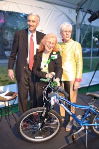 (Photo by Marilyn Rodriguez) Sarah Freeman (center) accepts a bicycle as part of her award from Emerald Necklace Conservancy board chair Ben Taylor and President Julie Crockford.