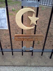 (Gazette Photo by John Ruch) A sign bearing a star-and-crescent Islamic symbol that was part of the marathon bombing victims memorial.
