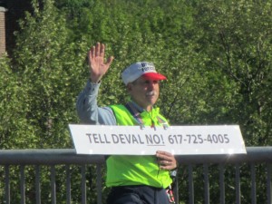 (Photo Courtesy Jim Kennedy) Bridging Forest Hills member Jeffrey Ferris holds up a sign urging drivers on the Casey Overpass to call Gov. Deval Patrick in support of a new bridge.