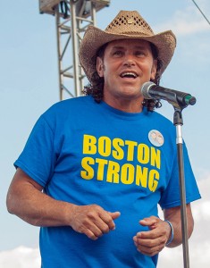 Peace activist Carlos Arredondo, who became world-famous for rescuing victims of the Boston Marathon bombing, speaks at the Revere Beach National Sand Sculpting Festival on the weekend of July 19, where he was among the heroes and victims honored in a giant sculpture of beach sand. The Roslindale resident is known for his anti-war displays in JP, and the local post office is dedicated to his son, a Marine killed in the Iraq War. (Photo by Ashley Falcucci)