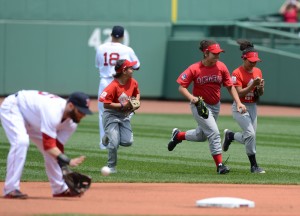 Members of the Jamaica Plain Angels youth softball team run onto the field at Fenway Park before a June 18 Red Sox baseball game. The Angels are part of the Red Sox-sponsored RBI League and were among various youth teams allowed to enter the field with the Sox as a special honor last month. (Photo Courtesy Boston Red Sox)