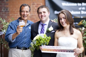 (from left) Samuel Adams beer founder Jim Koch raises a glass while serving as best man at the wedding of Pittsburgh, Pa. residents John and Kate Helter at the Samuel Adams Boston Brewery at 30 Germania St. June 26. The Helters were among six couples who married at the brewery during the annual event marking the release of the limited-edition wedding-themed “Brewlywed Ale.” The JP brewery is the test lab for the Boston Beer Company, makers of the Samuel Adams brand. For more upcoming events and unusual products, see samueladams.com. (Courtesy Photo)