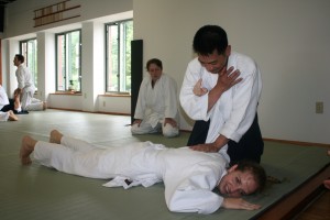 Chelsea Trendgrove is pinned by instructor Vu Ha while Kayleigh O'Conner observes. (Photo Courtesy Sarah Sarofum)