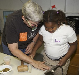 Beth Ireland (left) teaches woodworking to Karen Deller at South Street Youth Center in Jamaica Plain earlier this month. (Photo by Ron Cowie)