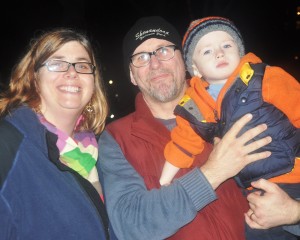 (from left) Kate, Roger and 2-and-a-half-year-old R.T. Skophammer of JP enjoy the City of Boston’s 72nd annual tree-lighting on the Boston Common Dec. 5. Mayor Thomas Menino (not pictured) lit the tree at the festival hosted by the Boston Parks and Recreation Department. (Photo by Jon Seamans/Boston Parks Dept.)