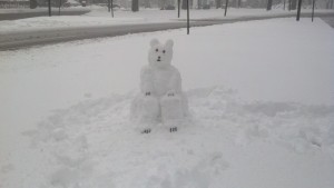 The “Arborway Polar Bear,” sculpted out of snow, makes its second annual appearance on the Arborway median near Kelley Circle on Feb. 6. “Regarding the local weather, he says, ‘Grin and “bear” it,’” said resident Sarah Freeman, who submitted this photo. (Photo Courtesy Sarah Freeman)