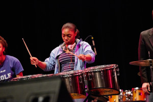 Nia Richardson, a student at English High School, plays the drums at Berklee College of Music’s Berklee City Music Faculty Outreach Concert on May 17. The finale of an after-school music program, the concert gave students a chance to join in a professional concert experience. (Photo by Dave Green)