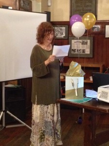 Sandee Storey reads an original poem during her acceptance of ESAC Boston’s 2014 Community Champion award on June 17 at Doyle’s Café. Storey has been a community advocate since the 1980s, as well as founding member of the Jamaica Plain Neighborhood Council and founding publisher and editor the JP Gazette. Last year’s ESAC Community Champion was state Rep. Liz Malia, who thanked Storey for her early guidance in Malia’s career. (Gazette Photo by Rebeca Oliveira)