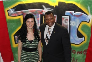 (from left) Art teacher Christine Hajjar and Suffolk County Sheriff Steven Tompkins stand in front of a banner at an exhibition of works by young artists at the Italian Home for Children in Jamaica Hills May 30. “I commend the Italian Home for Children for the work that they’re doing with the youth,” Tomkins said during his tour. “Sometimes these little opportunities are all that is needed to get and keep someone walking on the right path.” (Courtesy Photo)