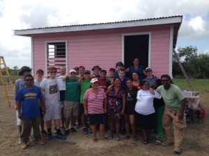 Jamaica Plain resident and Boston College High School guidance counselor Shawn Ahern (fourth from the left) joins other students in helping to build a house in the Central American country of Belize during a recent trip. The project was done through the organization Hand in Hand Ministries, which provides housing for people in Appalachia and Central America. (Courtesy Photo)