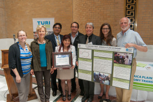 Myra and Ernesto Vargas (center), from J&P Cleaners, accept a grant from Massachusetts Toxics Use Reduction Institute to cover part of the cost of switching to nontoxic cleaning chemicals last month. With them are (from left): Claire Miller (Toxic Action Center), Polly Hoppin (Lowell Center for Sustainable Production), Carlos Espinoza-Toro and Chuck Collins (JP New Economy Transition), Molly Jacobs & Dr. Richard Clark (Lowell Center for Sustainable Production). (Photo Courtesy TURI)