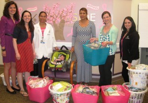 New mother Leidys Sosa (third from right) and her baby are among the patients of Brigham and Women’s Hospital’s Midwifery Program at JP’s Brookside Community Health Center who recently received baskets of essential baby items from various employees, including (from left) Partners HealthCare’s Maggie Corcoran and Melissa Shrestha; and the health center’s Alba Garcia, Maria Bianciardi and Daisy Ocasio. (Courtesy Photo)