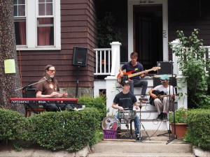 Rick Berlin with the Nickel and Dime Band play during the first annual Jamaica Plain Porchfest on July 19, where bands played on porches and lawns around the neighborhood. Mindy Fried, an organizer of the music event, said that between 7,000 and 8,000 people attended the Porchfest. “The feedback has been overwhelmingly positive and it’s very moving for us. We believe that this speaks to the universal power of music and people’s hunger for community,” she said. (Photo by Sue Dorfman)